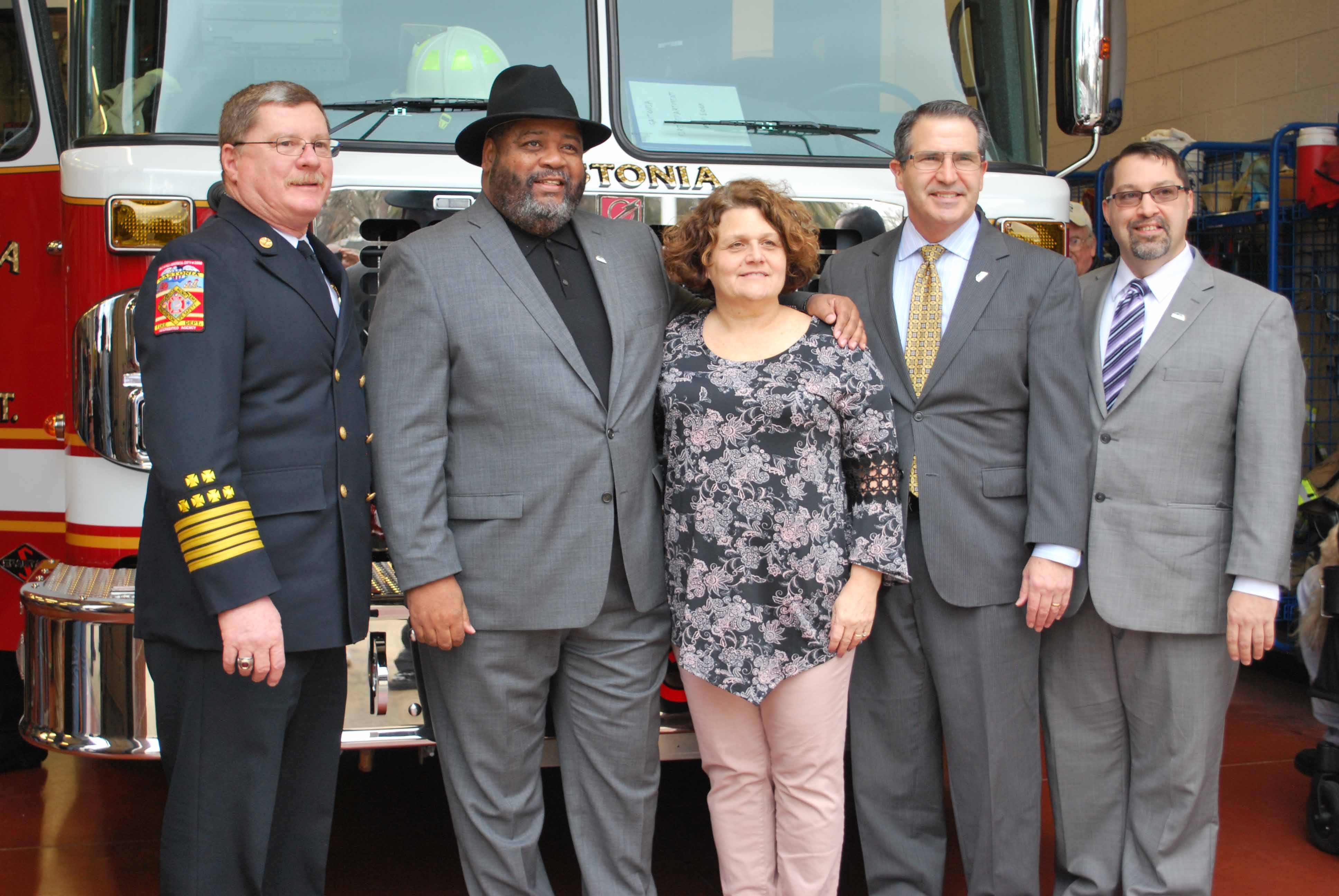 City officials pose for photos with the new fire truck